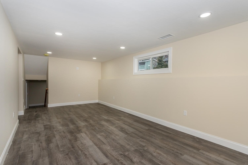 71 Morton Street Canton, MA 02021 - Photo 29 of 39 an empty room with wooden floor and a window