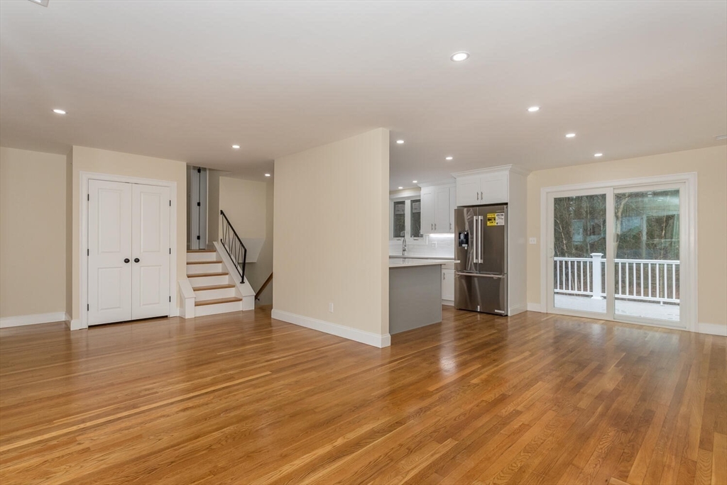 71 Morton Street Canton, MA 02021 - Photo 8 of 39 a view of an empty room with wooden floor and a kitchen
