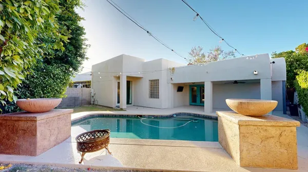 a view of house and outdoor space with swimming pool