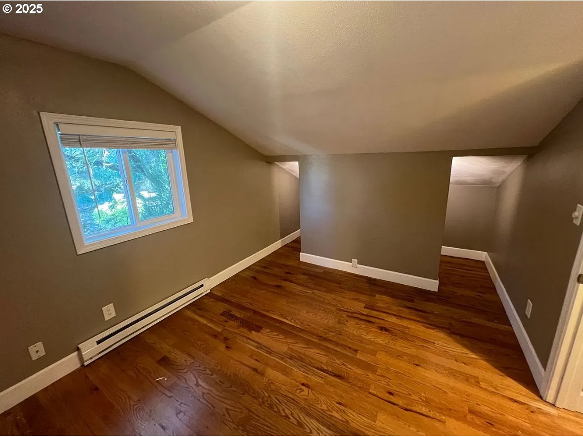 8031 Southeast Orient Drive Gresham, OR 97080 - Photo 6 of 17 a view of an empty room with wooden floor and a window