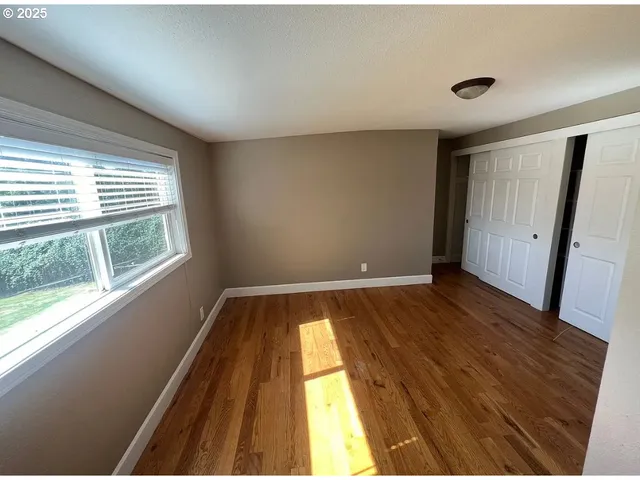 a view of wooden floor in an empty room