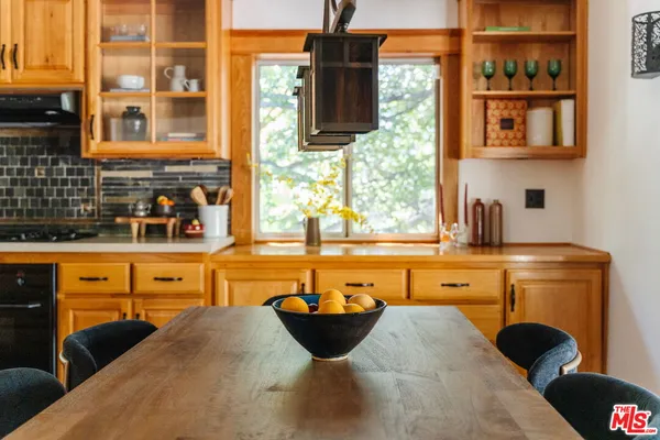 a large kitchen with stainless steel appliances granite countertop a stove a sink and a microwave