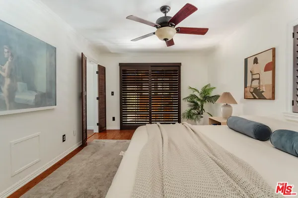 a bedroom with a large bed and a large window