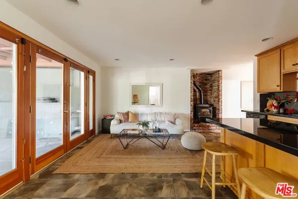 a living room with furniture and a floor to ceiling window