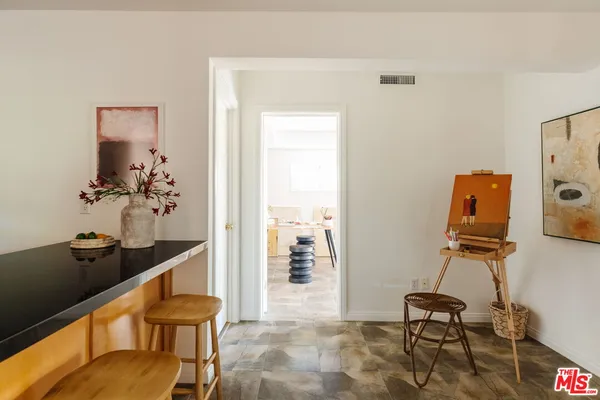 a view of a workspace with furniture and a gate