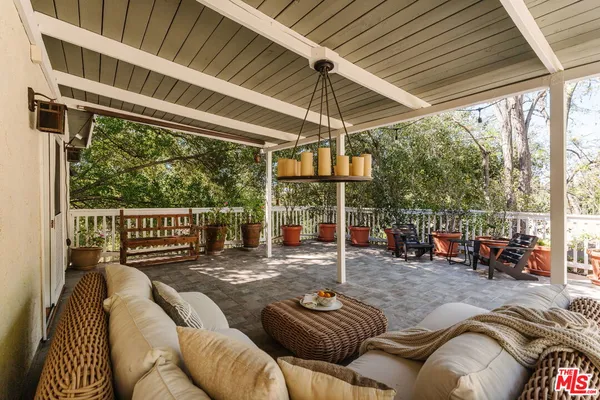 a outdoor space with patio the couches and chairs with wooden floor