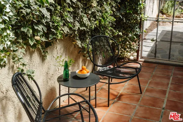 a backyard of a house with table and chairs