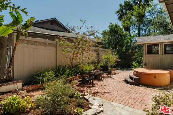 a backyard of a house with a tree