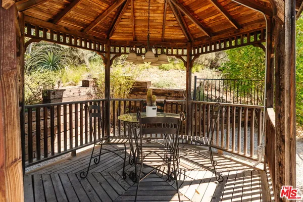 a yellow house with flower plants in front of it
