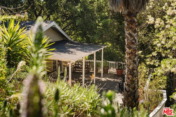 a view of a house with a tree
