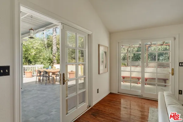 a view of a room with furniture wooden floor and glass door