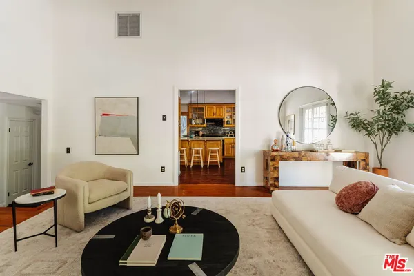 a living room with furniture a rug and a large window