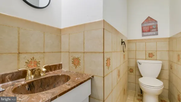 a bathroom with a toilet sink and mirror