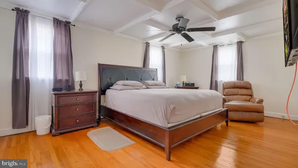 a bedroom with a bed and a ceiling fan