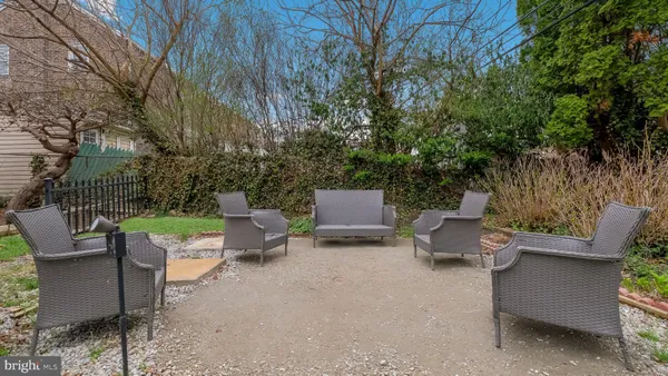 a view of a patio with a table and chairs and potted plants