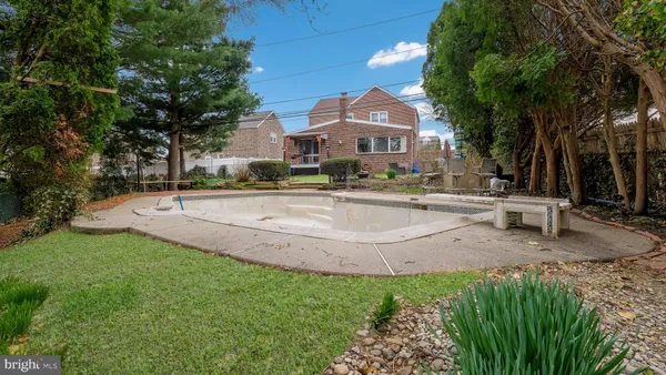 a view of a house with a yard and sitting area