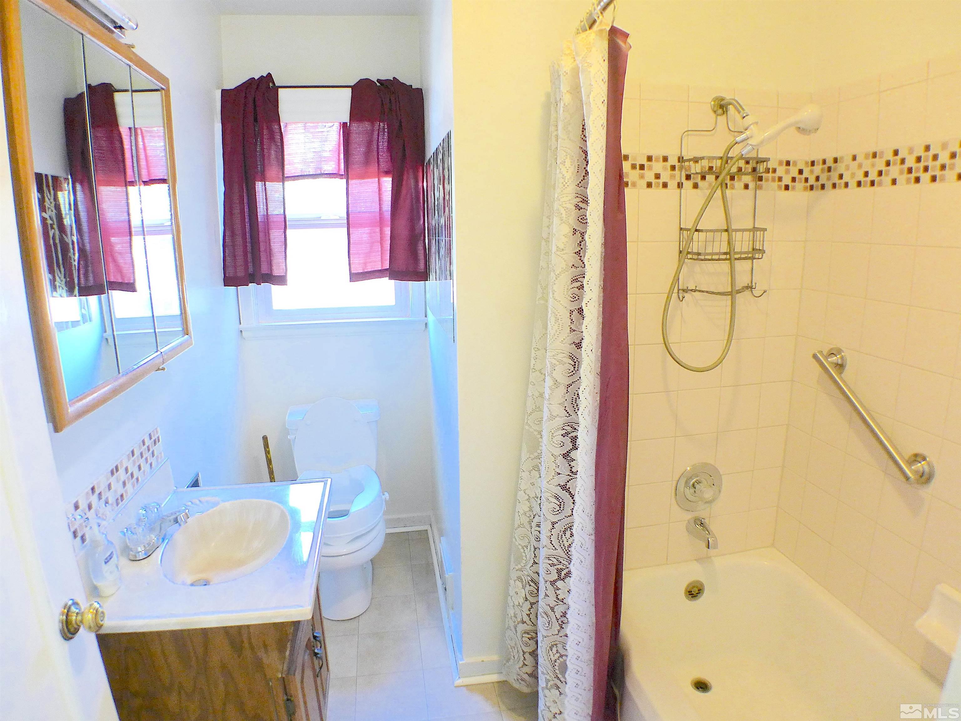 1285 Tacoma Way Reno, NV 89509 - Photo 8 of 10 a bathroom with a granite countertop sink and a mirror