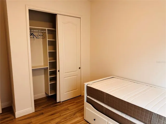 a view of walk in closet with empty racks