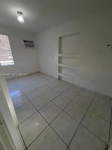 a view of an empty room and a window