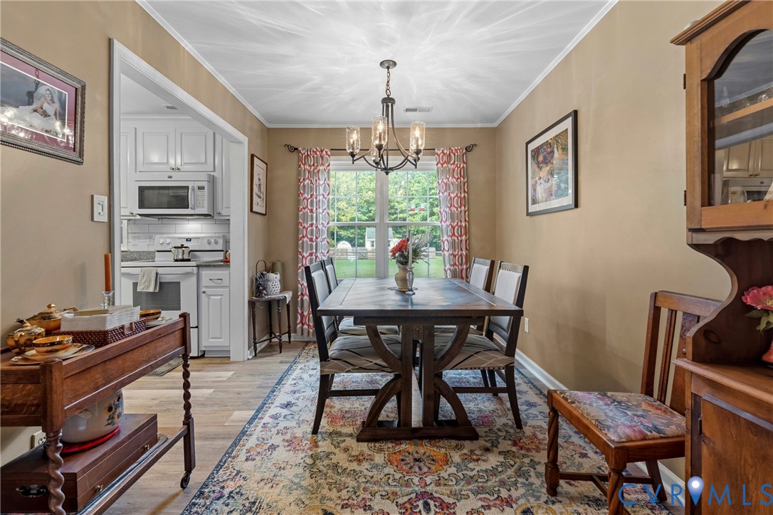 5010 Tatum Road Disputanta, VA 23842 - Photo 13 of 50 Formal dining area with wood-finish flooring, chan