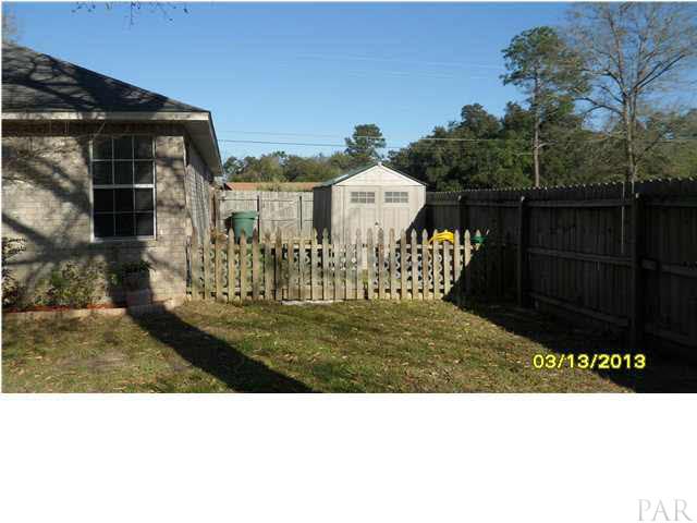7417 Woodside Road Pensacola, FL 32526 - Photo 22 of 25 FENCED AREA FOR PETS AND A STORAGE BUILDING ON GARAGE SIDE OF HOME