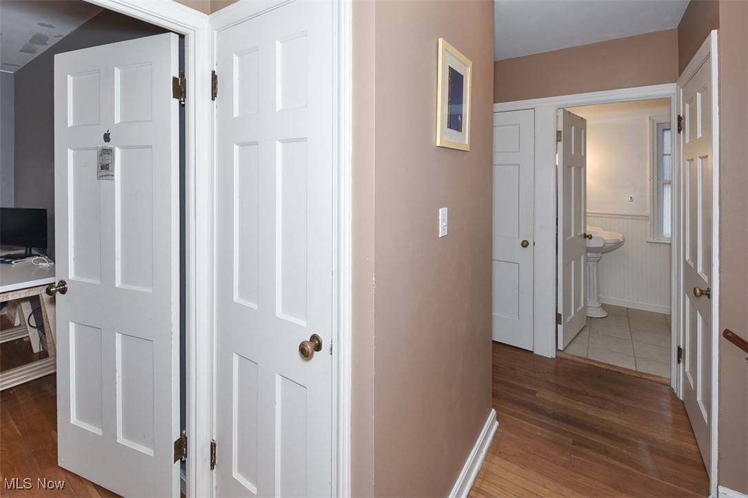 2469 Queenston Road Cleveland, OH 44118 - Photo 17 of 37 Corridor featuring a wainscoted wall and wood finished floors