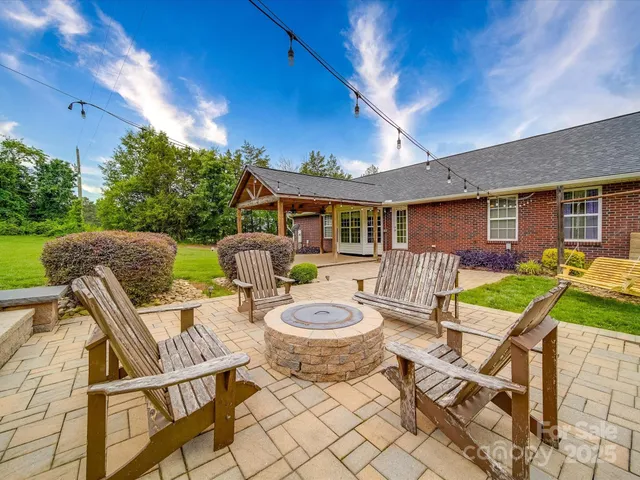a patio with a table and chairs and a barbeque