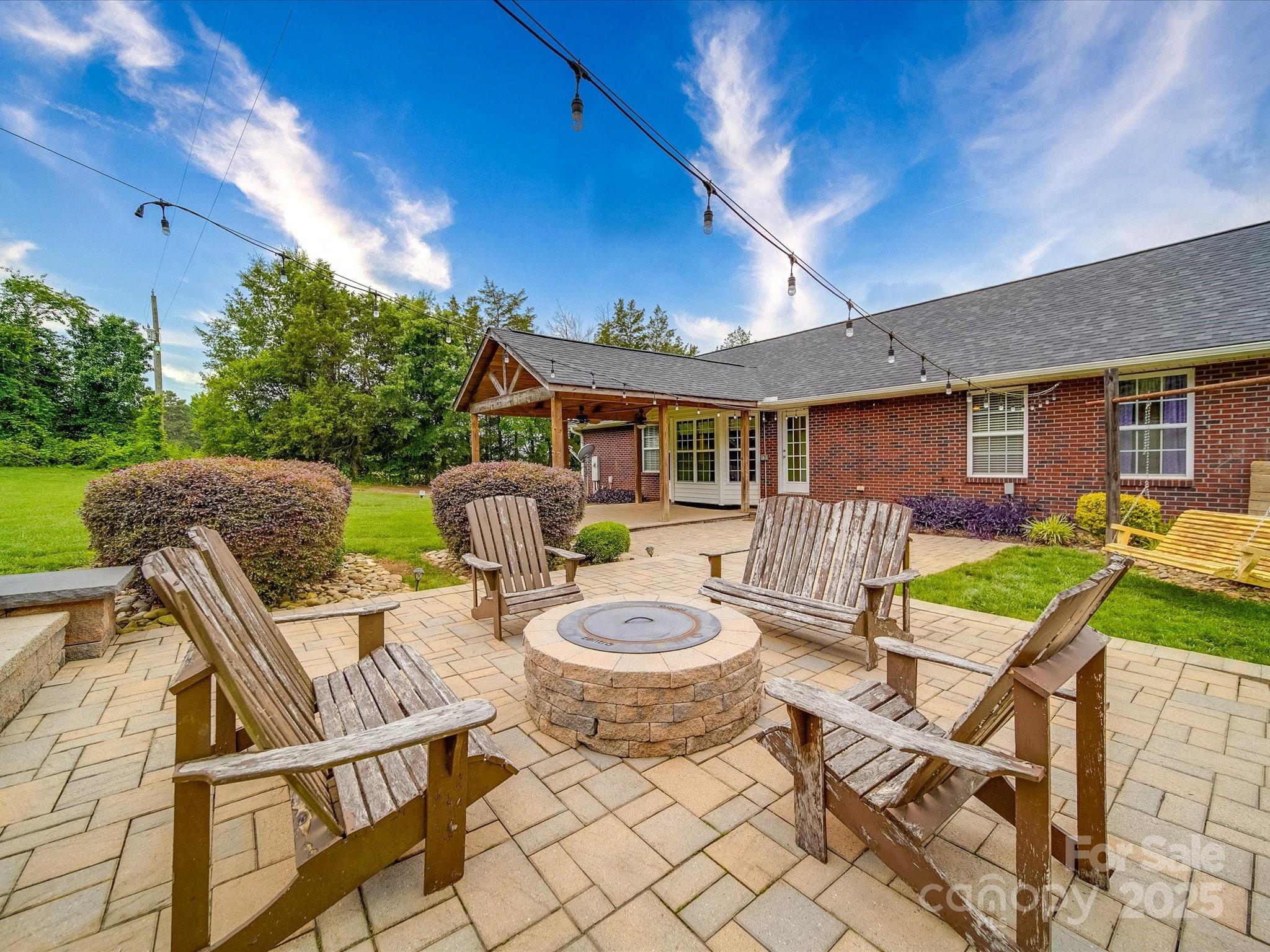 1060 South Lentz Harness Shop Road Mount Pleasant, NC 28124 - Photo 11 of 48 a patio with a table and chairs and a barbeque