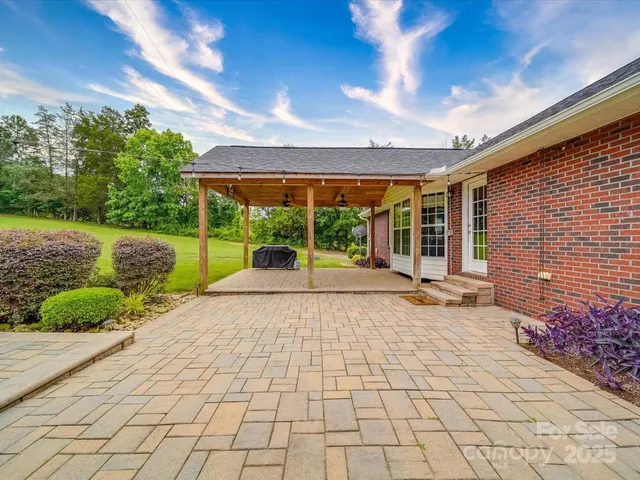 a view of a patio with a table and chairs under an umbrella