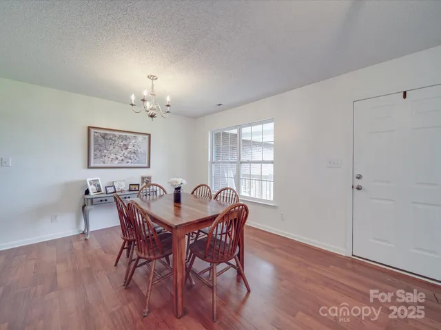 a view of a dining room with furniture and window