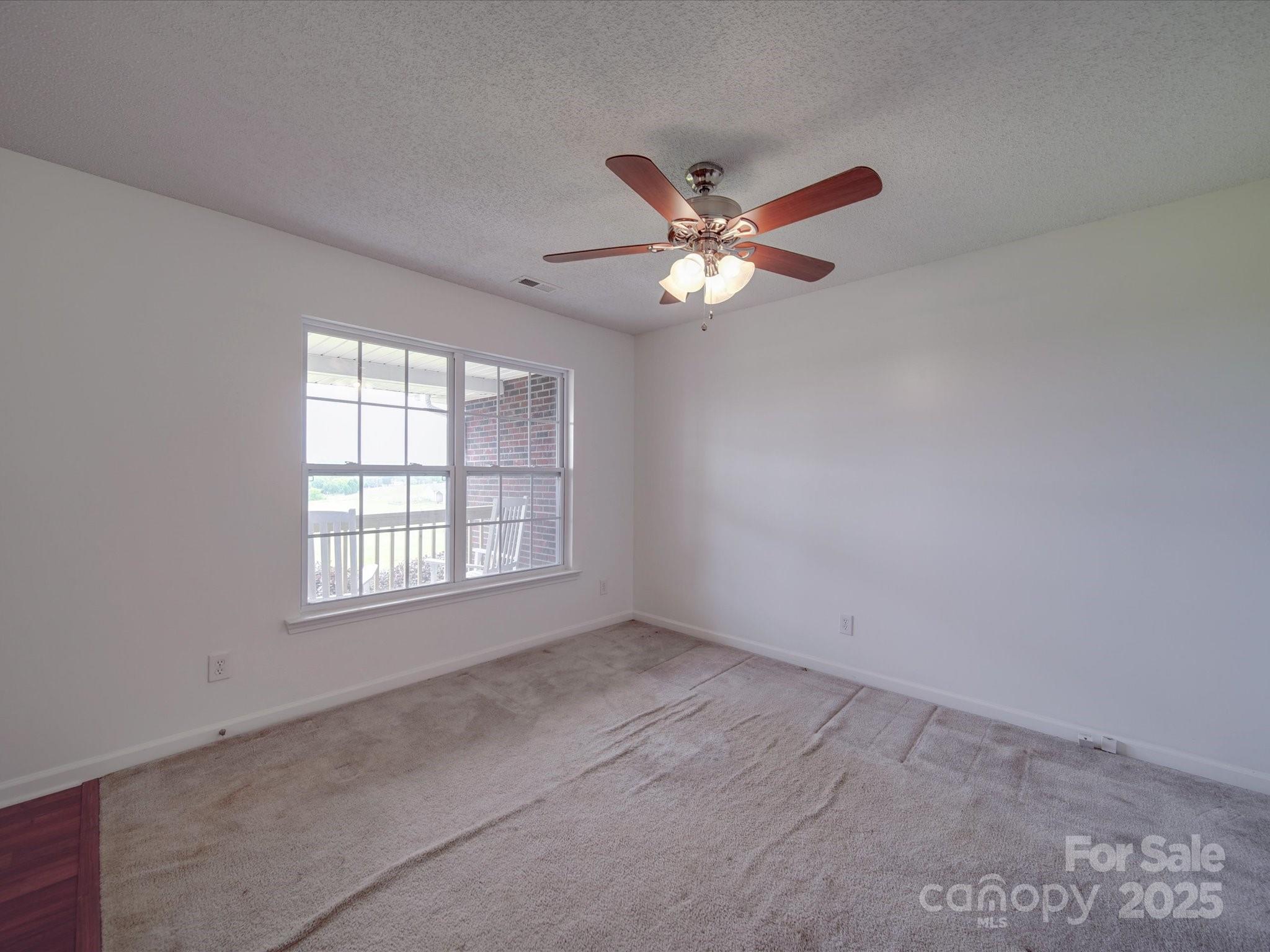 1060 South Lentz Harness Shop Road Mount Pleasant, NC 28124 - Photo 19 of 48 an empty room with a window and a fan