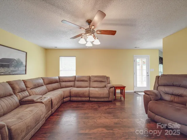 a living room with furniture a couch and wooden floor