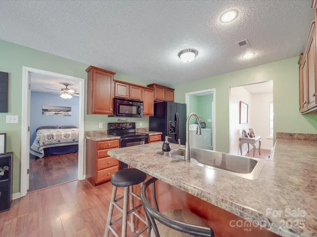 a kitchen with granite countertop a sink and cabinets
