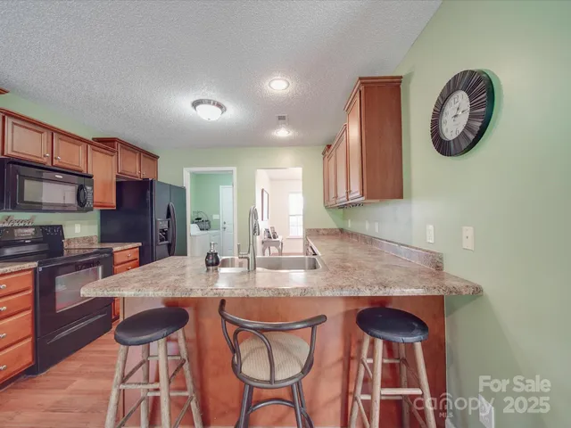 a kitchen with a table chairs sink and cabinets
