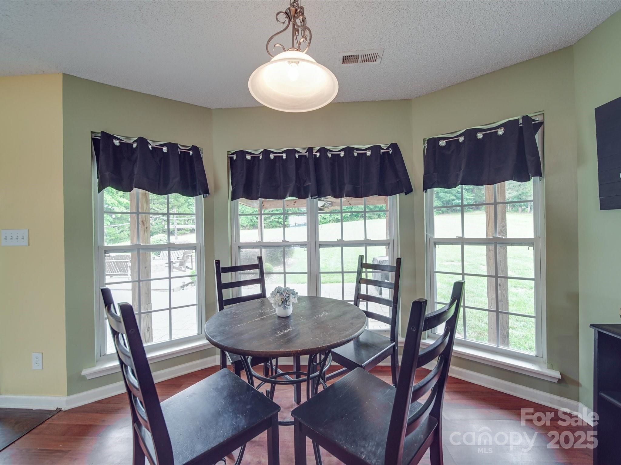 1060 South Lentz Harness Shop Road Mount Pleasant, NC 28124 - Photo 30 of 48 a view of a dining room with furniture a chandelier and wooden floor