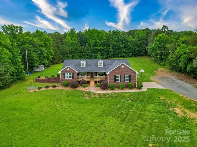 a front view of a house with yard and green space