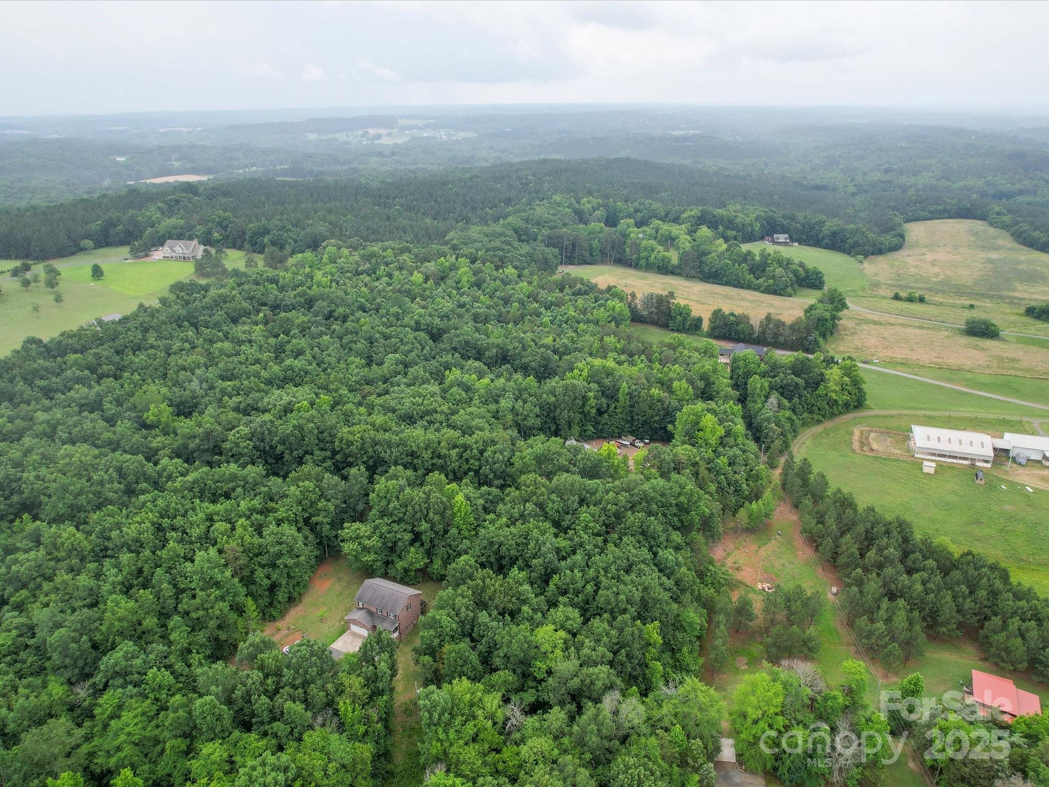 1060 South Lentz Harness Shop Road Mount Pleasant, NC 28124 - Photo 46 of 48 an aerial view of residential houses with outdoor space and trees