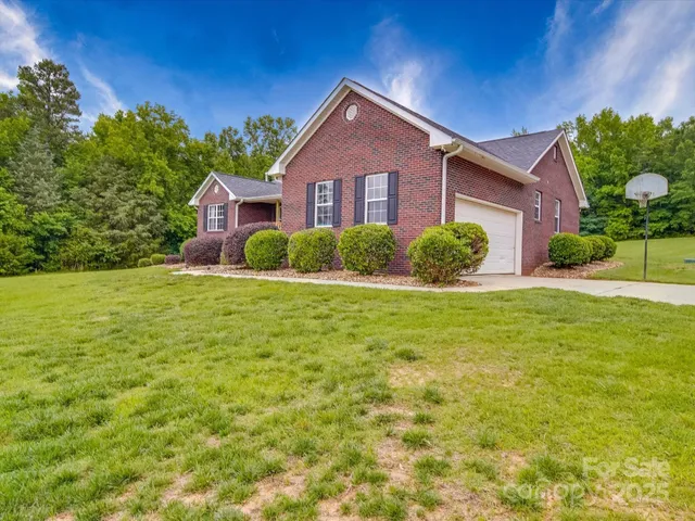 a front view of house with yard and green space