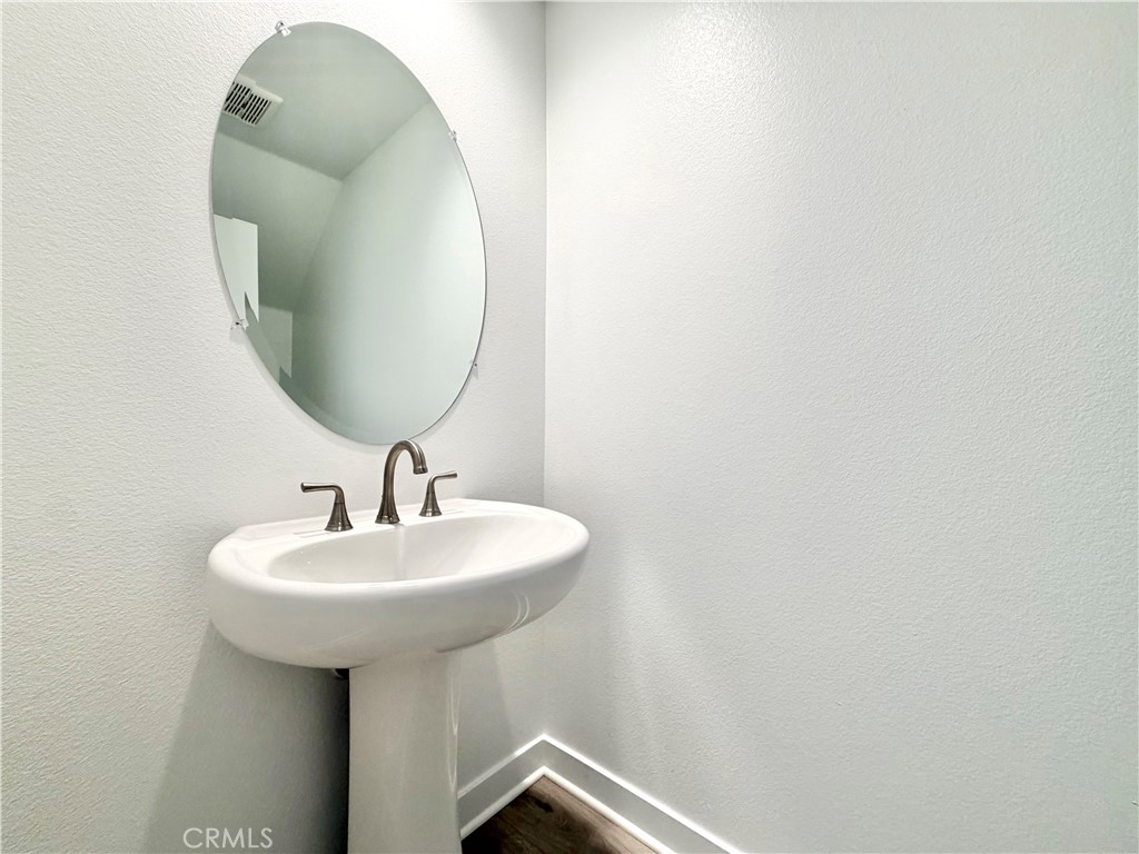 26893 Rubicon Road Menifee, CA 92586 - Photo 11 of 32 a bathroom with a sink and mirror