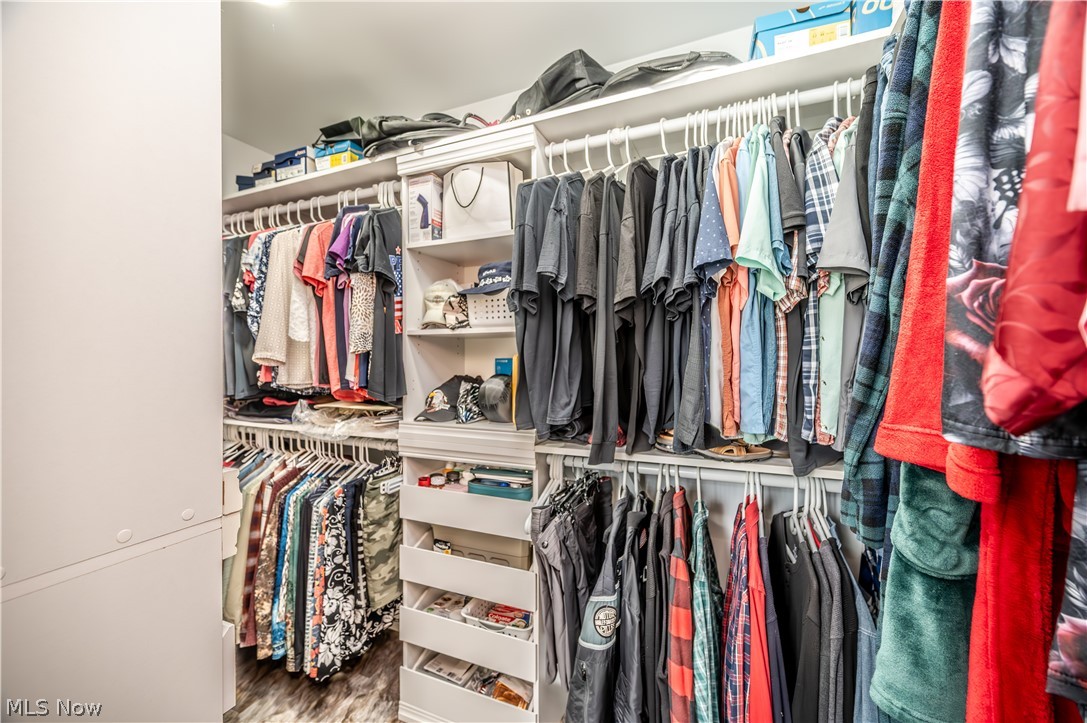405 Airport Road Northwest Warren, OH 44481 - Photo 29 of 50 Custom closet system featuring multiple hanging rods, open shelving, and built-in drawers