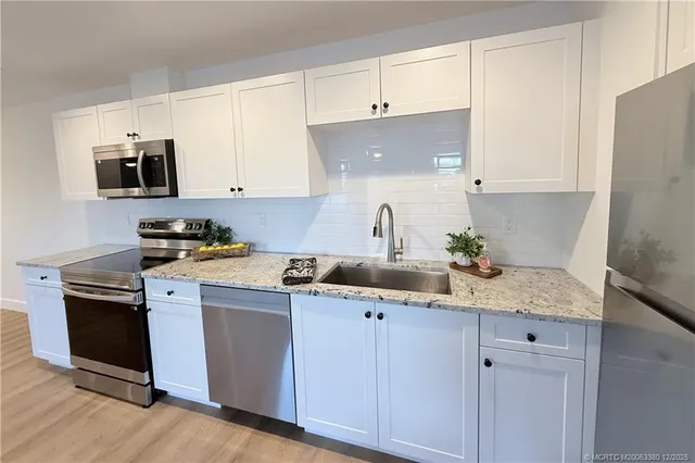 a kitchen with a refrigerator stove and microwave