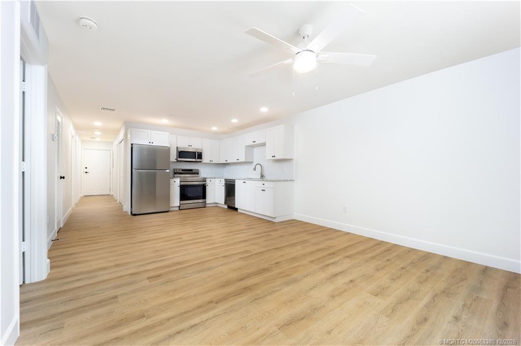 3375 Southwest Mapp Road, Unit 206 Palm City, FL 34990 - Photo 3 of 34 a view of empty room with wooden floor
