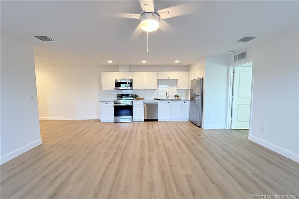 3375 Southwest Mapp Road, Unit 206 Palm City, FL 34990 - Photo 32 of 34 a view of kitchen with refrigerator stove microwave and cabinets