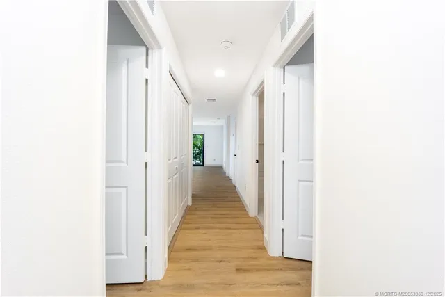 a view of a hallway with wooden floor