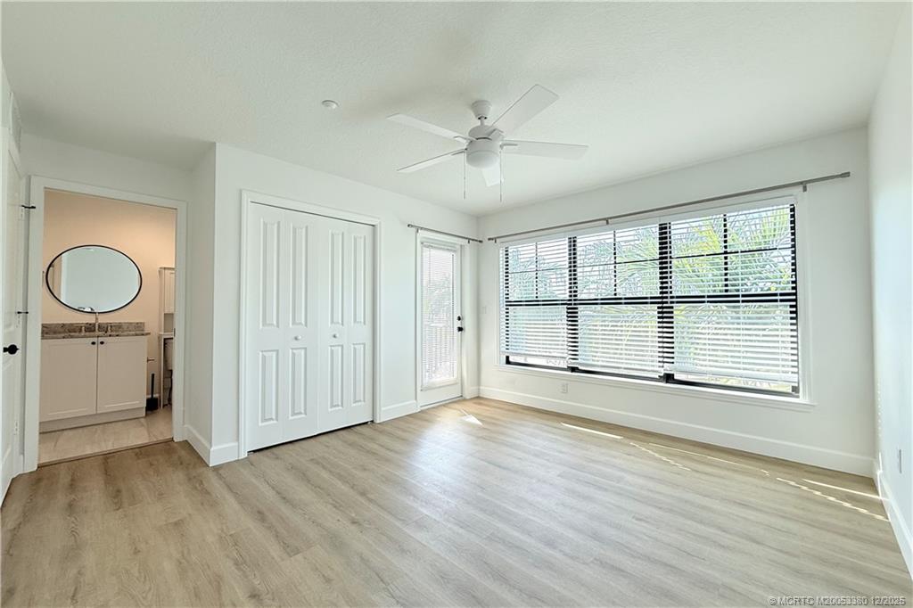 3375 Southwest Mapp Road, Unit 206 Palm City, FL 34990 - Photo 6 of 34 a view of an empty room with a window and wooden floor