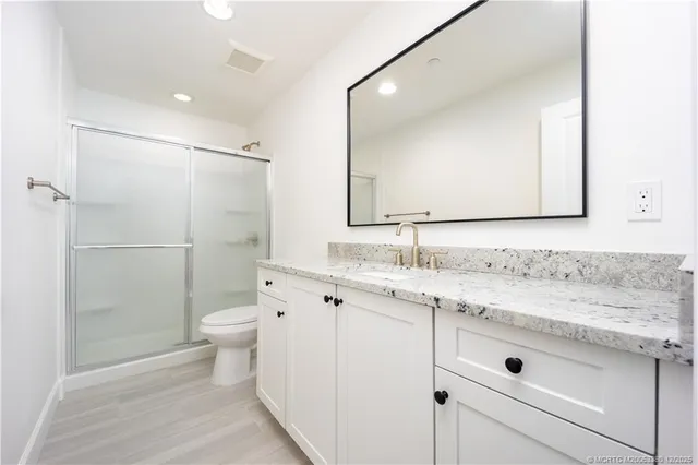 a bathroom with a sink toilet and shower