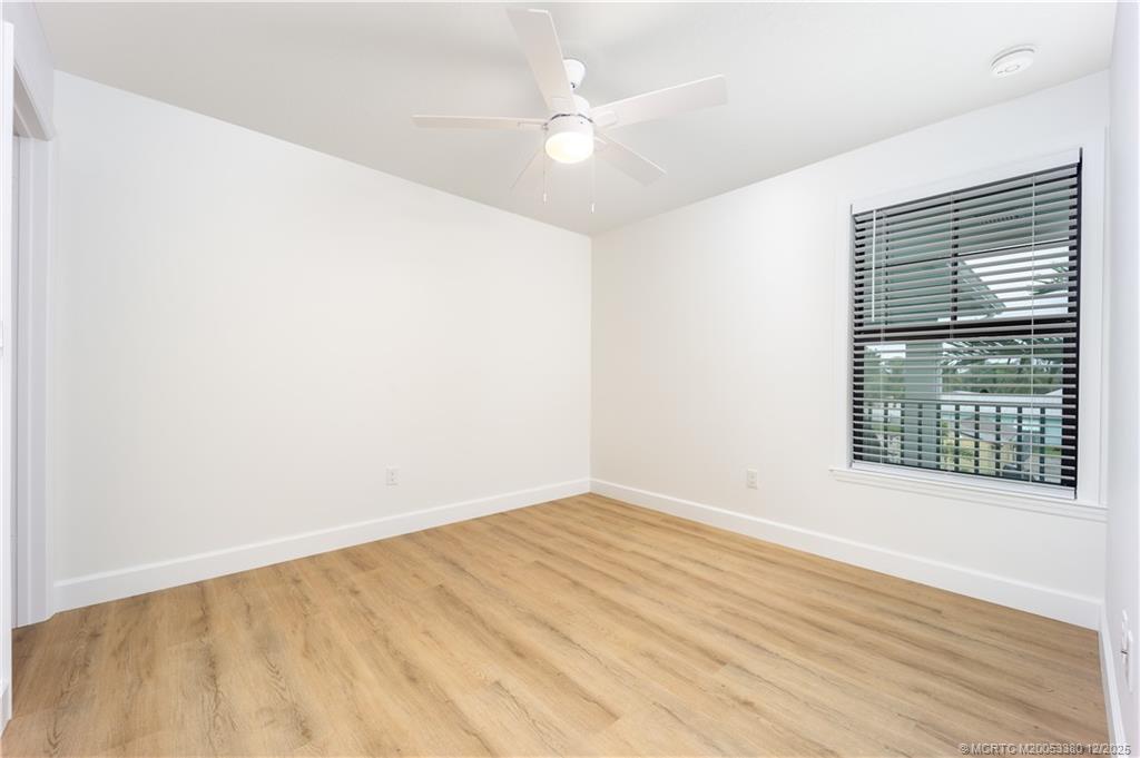 3375 Southwest Mapp Road, Unit 206 Palm City, FL 34990 - Photo 10 of 34 an empty room with wooden floor and windows