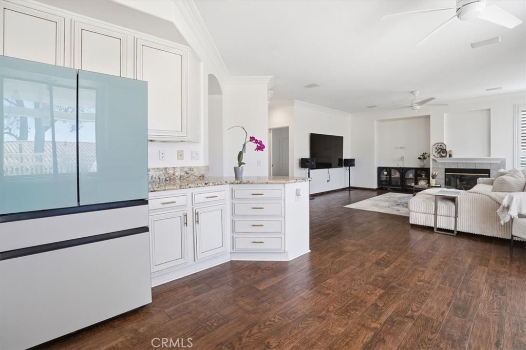 768 Ochee Circle Corona, CA 92879 - Photo 26 of 75 a living room with furniture a flat screen tv and a fireplace