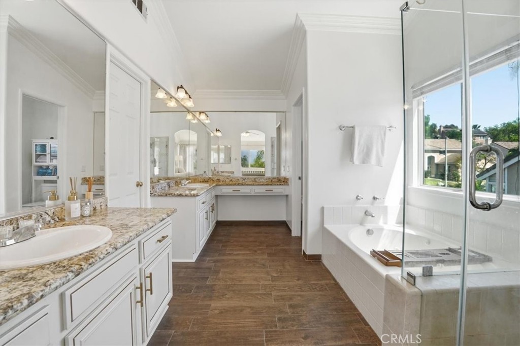 768 Ochee Circle Corona, CA 92879 - Photo 45 of 75 a large bathroom with a granite countertop double vanity sink a mirror and a bathtub