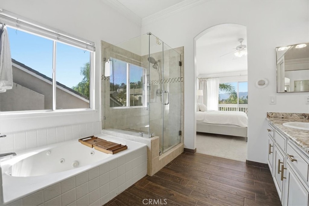 768 Ochee Circle Corona, CA 92879 - Photo 47 of 75 a bathroom with a tub a sink and a large window